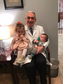 Dr Sharara holding Jessica & Stephanie's children